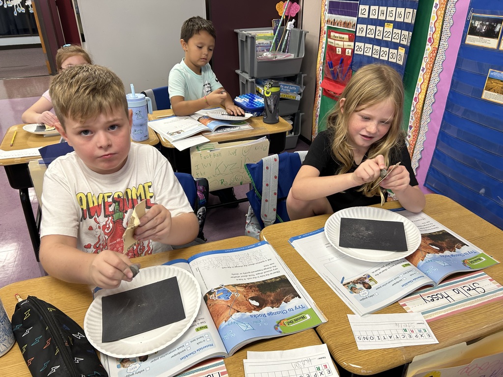 How does the land change? The students modeled "weathering" by rubbing rocks with sandpaper to show how land changes over time.