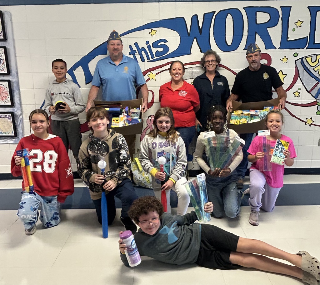 American Legion members presenting a group of students with school supplies