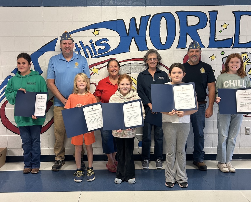 Five students standing with their certificates presented by American Legion members for an essay contest