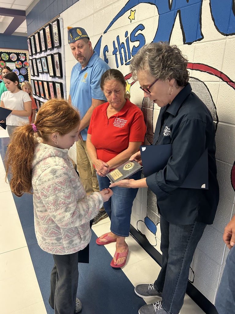One student receiving an award for being recognized in an Americanism essay contest