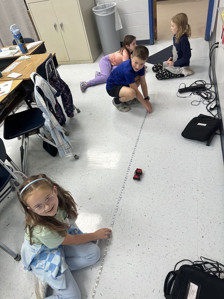 Mrs. Rogers’ 3rd grade class investigates the effects of force and motion through a hands-on experiment using a toy car, tape measure, masking tape, and stopwatch.