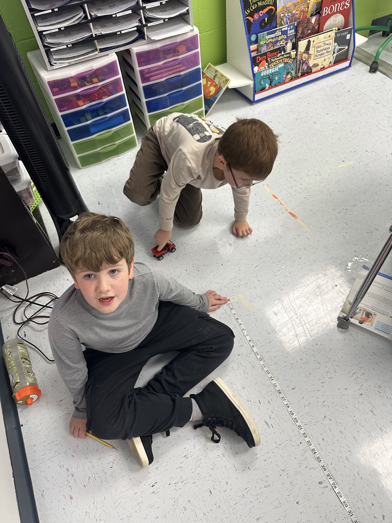 Mrs. Rogers’ 3rd grade class investigates the effects of force and motion through a hands-on experiment using a toy car, tape measure, masking tape, and stopwatch.