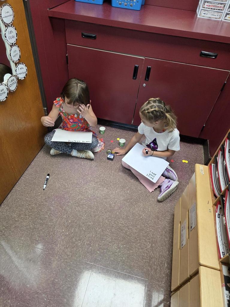 Students in Mrs. Redman's class are actively building their addition skills to 5 through collaborative partner games."
