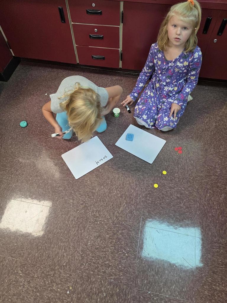 Students in Mrs. Redman's class are actively building their addition skills to 5 through collaborative partner games."