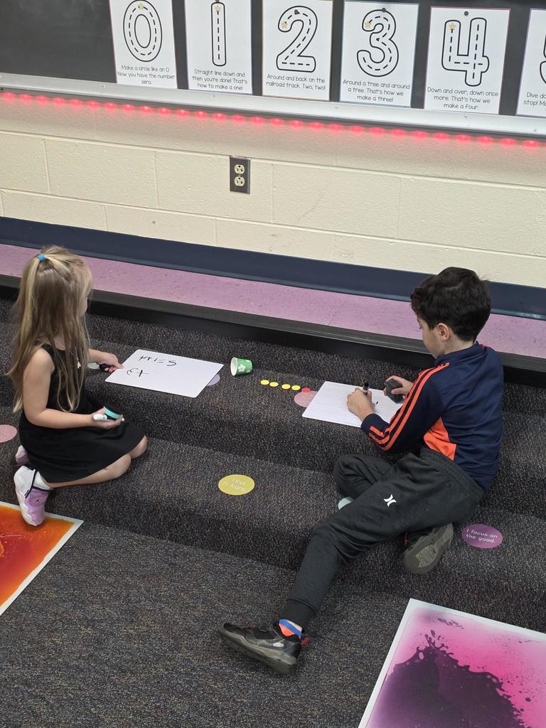 Students in Mrs. Redman's class are actively building their addition skills to 5 through collaborative partner games."