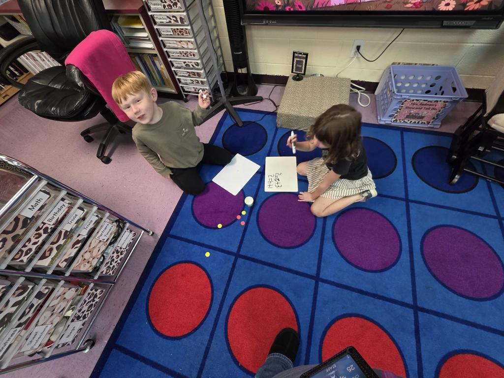 Students in Mrs. Redman's class are actively building their addition skills to 5 through collaborative partner games."