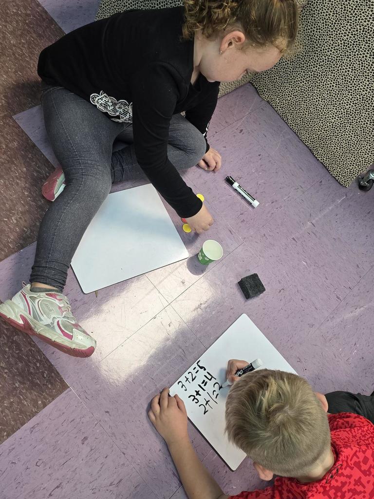 Students in Mrs. Redman's class are actively building their addition skills to 5 through collaborative partner games."