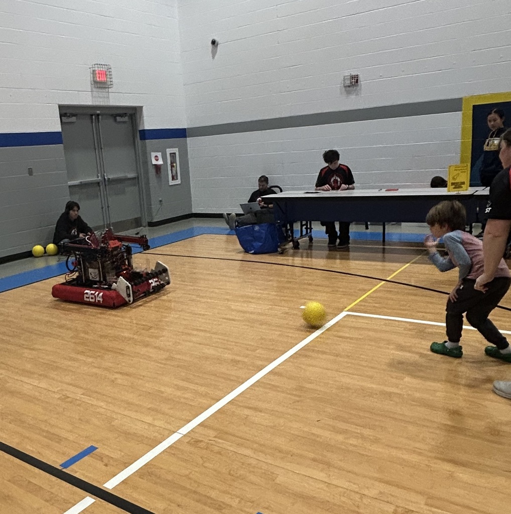 Ball retrieving robot from WVU robotics playing catch with a student