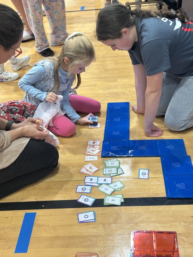 STEM night, girl coding robot on a course