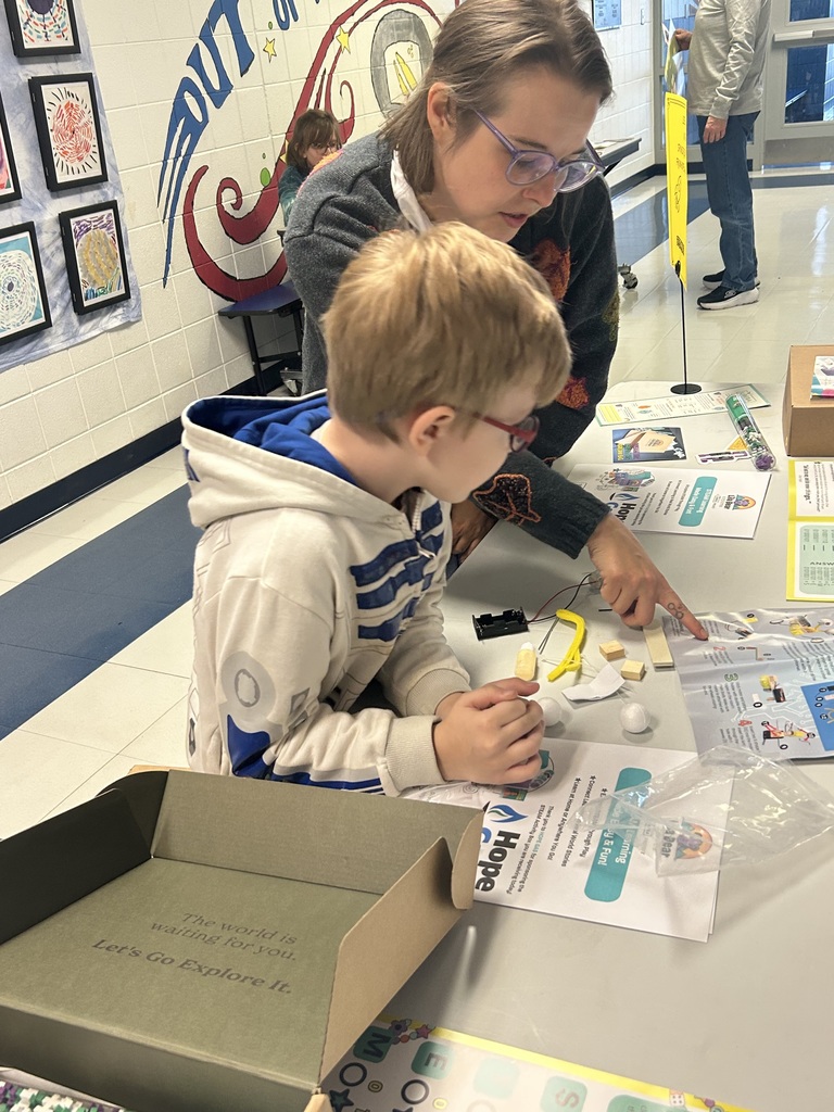 Male student putting together a coding robot