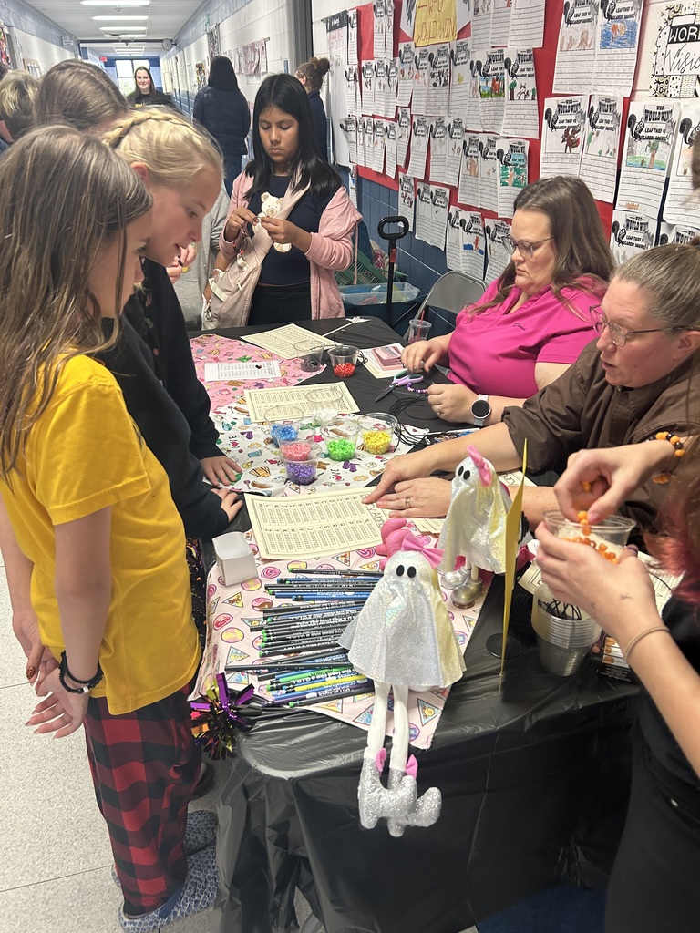 Group of girls creating different STEM activities with the Girl Scout leaders