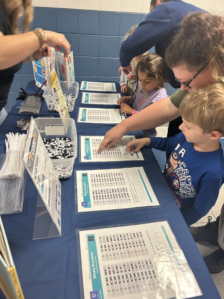 students and parents making binary code bracelets