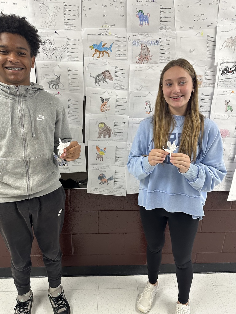 2 students holding something printed from a 3 D printer