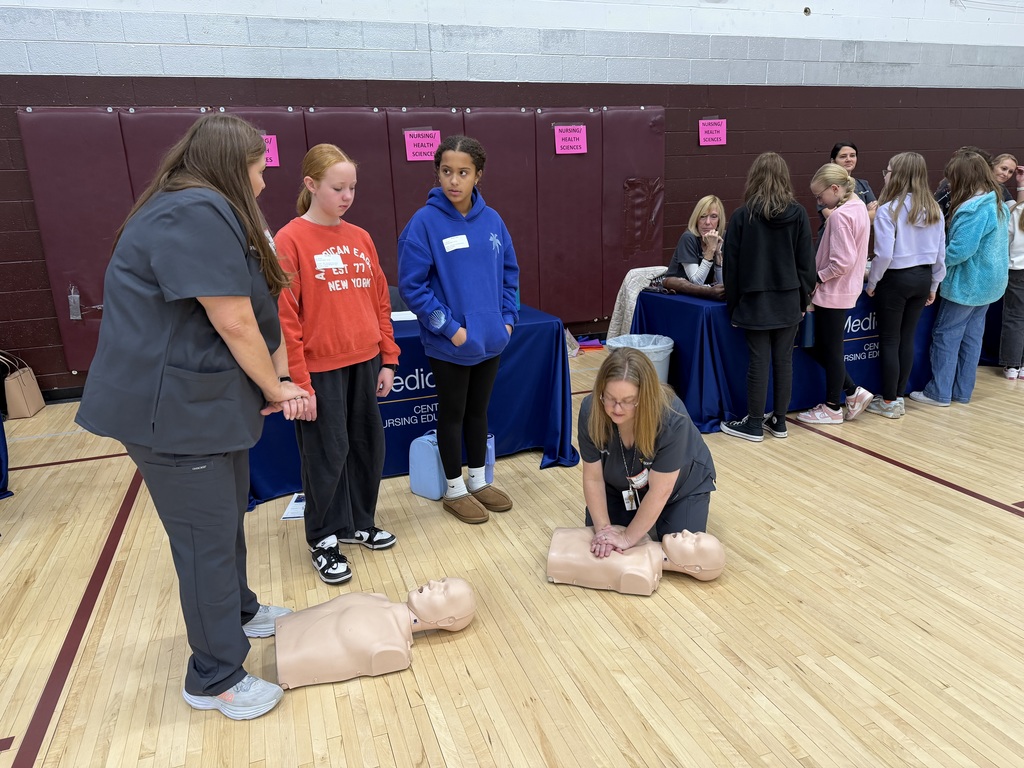 Nurse showing students how to give CPR