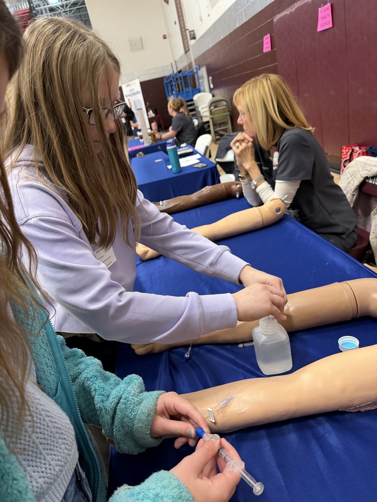 Students practicing giving a shot