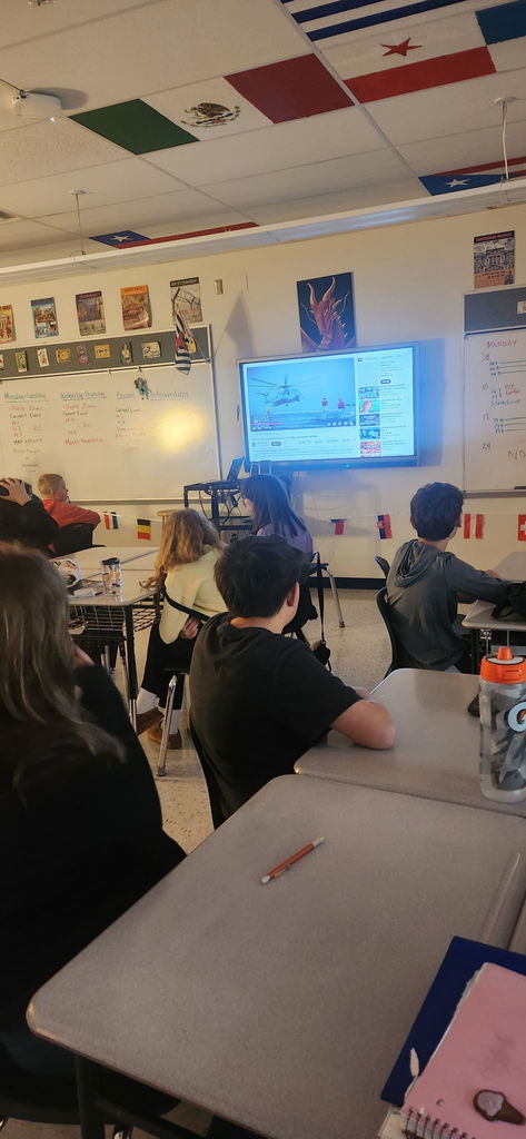 Students watching a screen