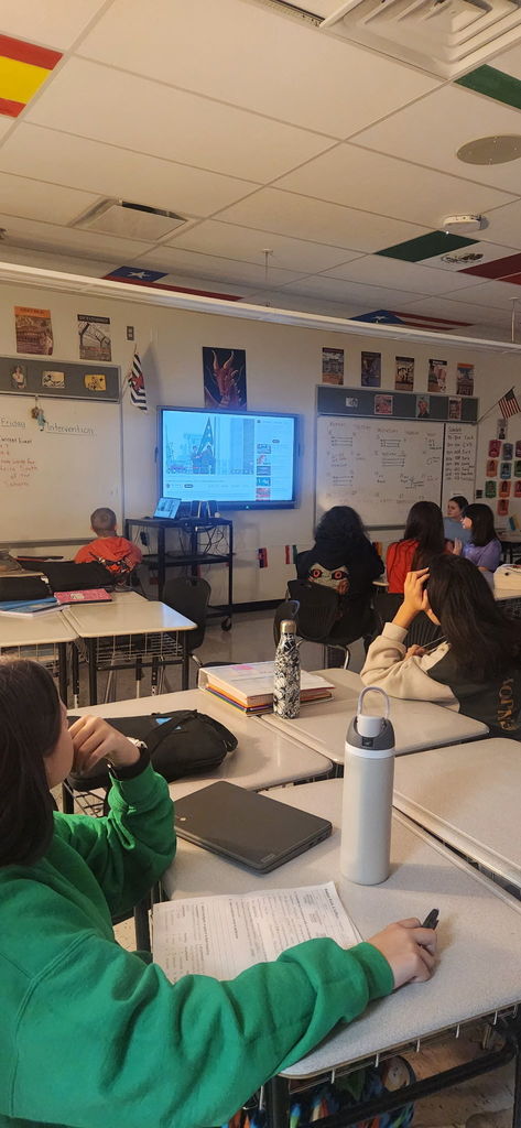 Students watching a screen