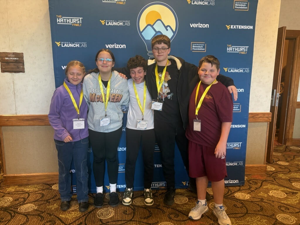 students standing in front of a poster