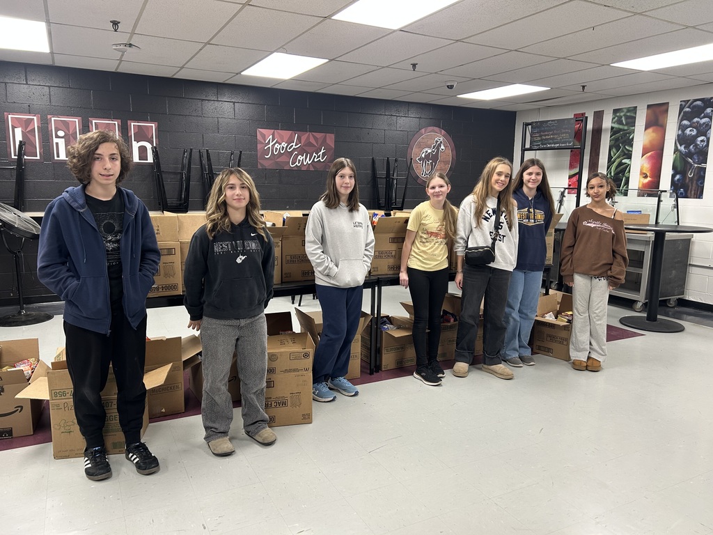 students standing with boxes