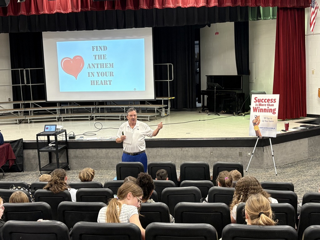 Man talking to students in an auditorium 