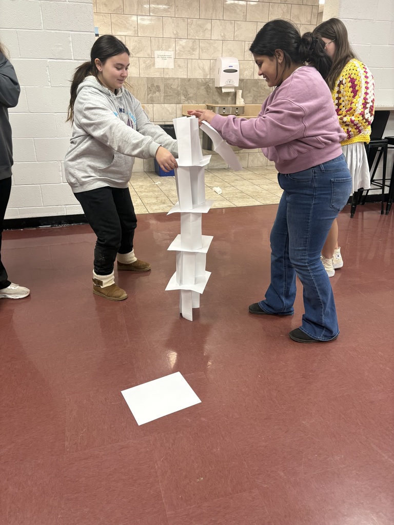 students building a paper tower
