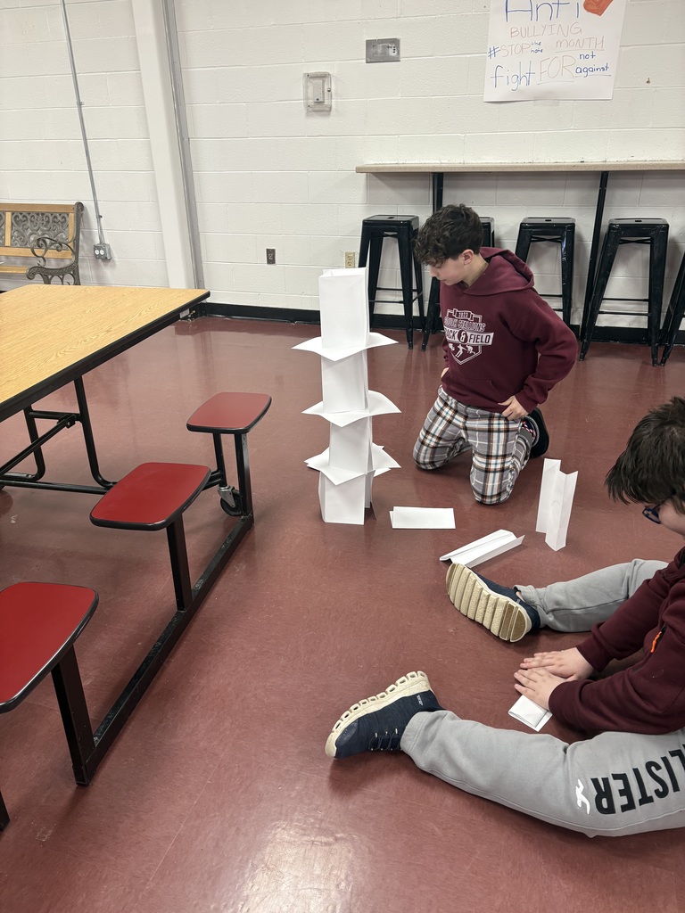 students building a paper tower