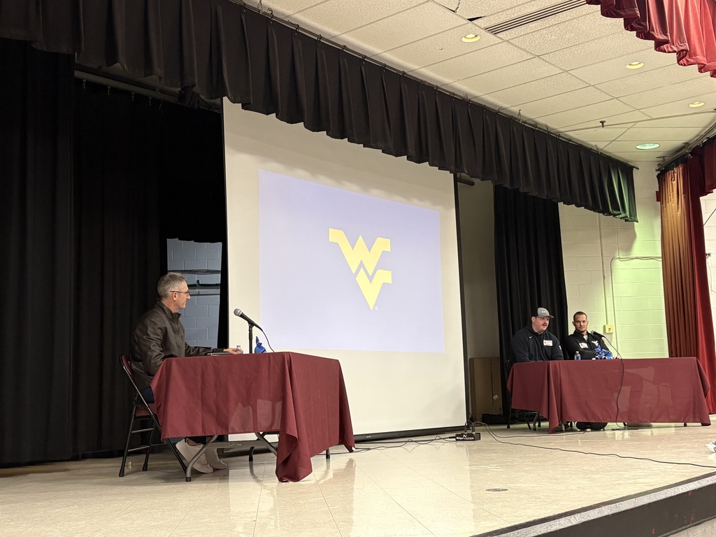 2 Athletes sitting at a table being interviewed