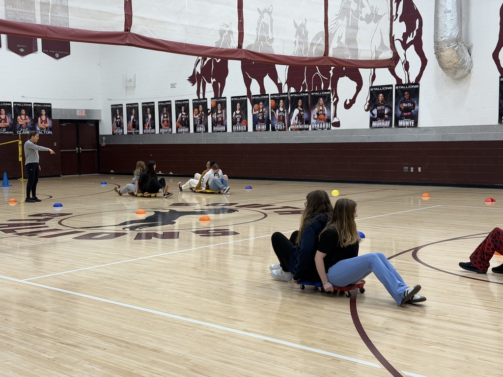 Students on scooters in the gym