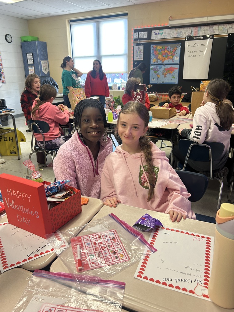 two fifth grade girls smiling with valentines