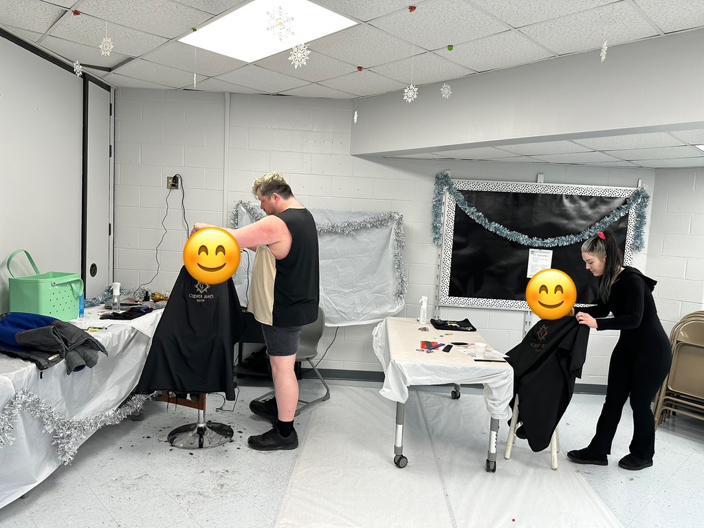Picture shows students getting haircuts at school