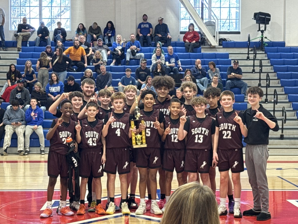 Boys basketball team holding a trophy