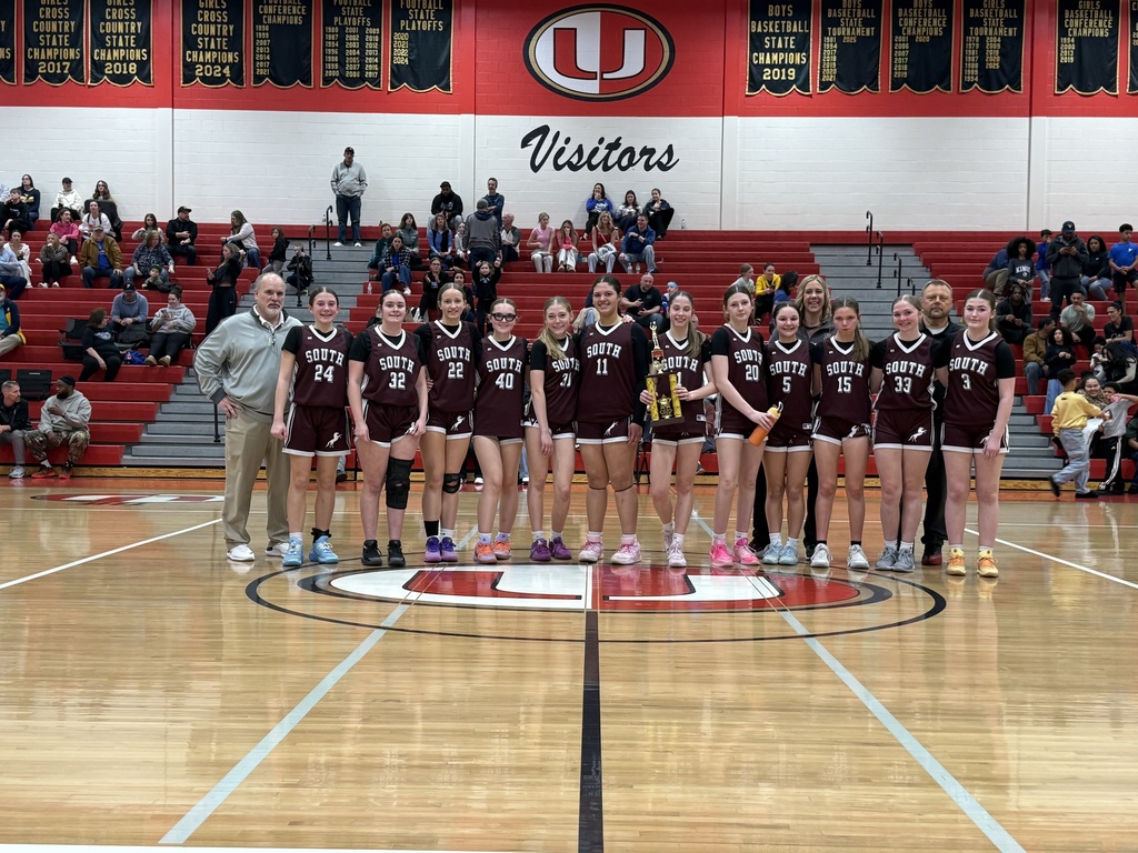 Girls basketball team holding a trophy