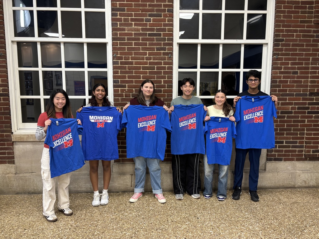 Students standing with tshirts
