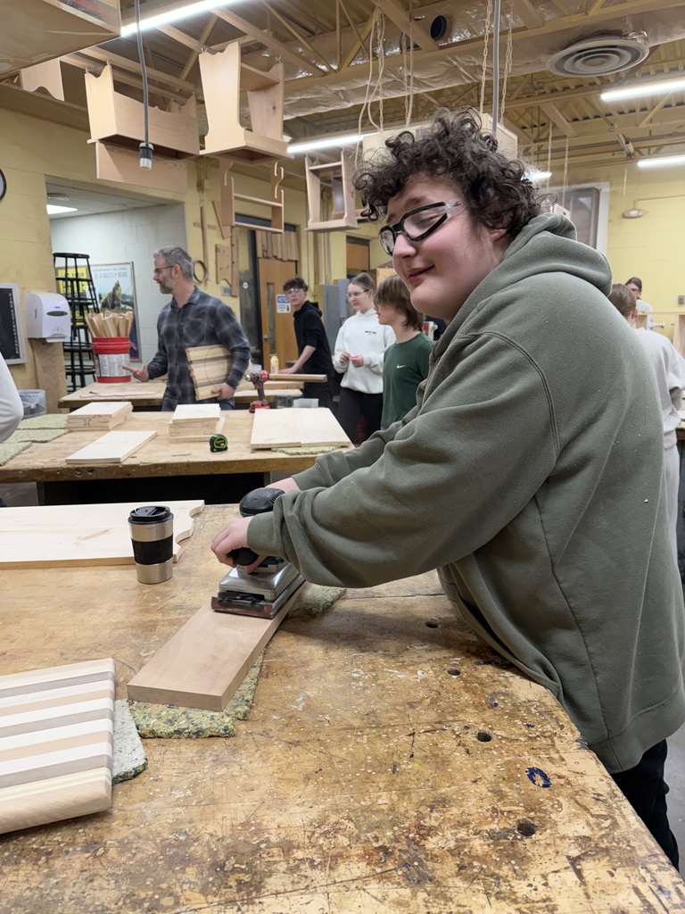 Student sanding a piece of wood