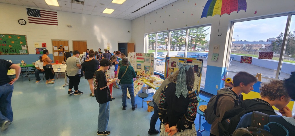 Families gather around tables, learning about cultures