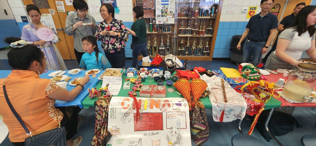 Chinese booth at the festival, showcasing food, facts, and cultural wear
