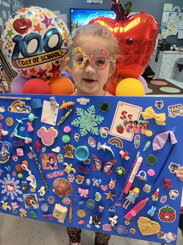 PreK student in front of balloons celebrating 100 days with a poster project!
