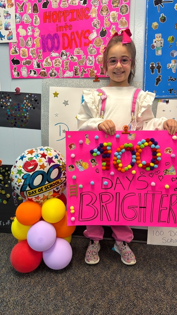PreK student in front of balloons celebrating 100 days!
