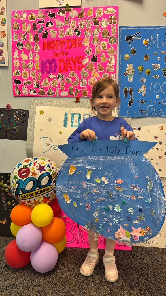 PreK student in front of balloons celebrating 100 days!
