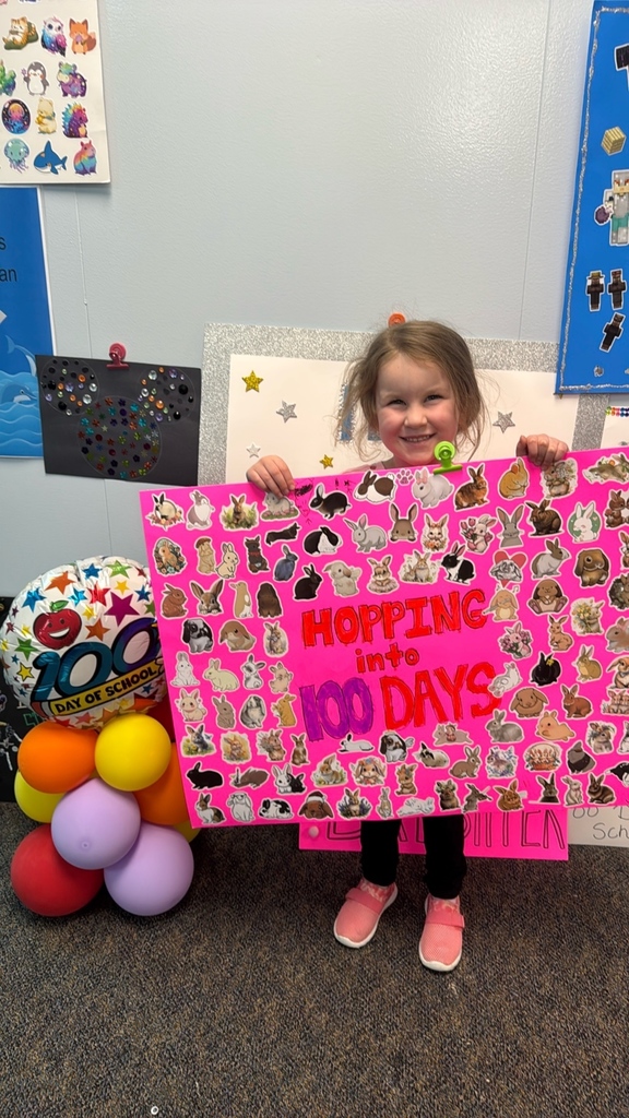 PreK student in front of balloons celebrating 100 days!