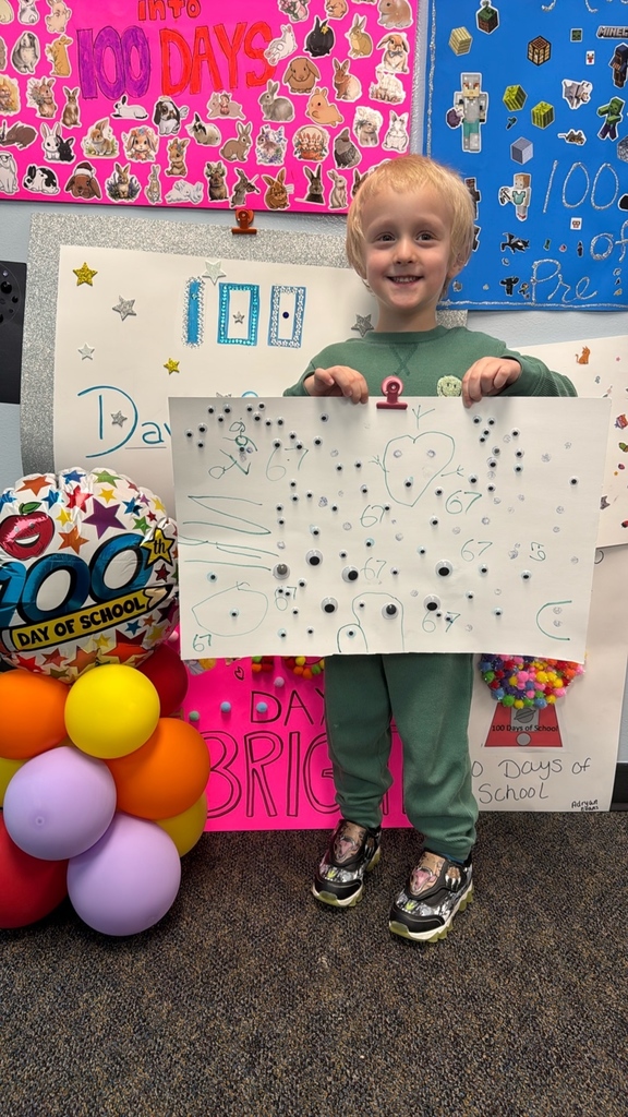 PreK student in front of balloons celebrating 100 days!