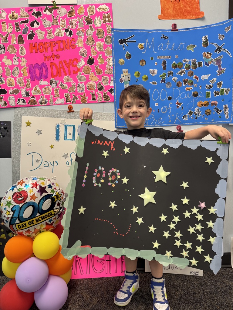 PreK student in front of balloons celebrating 100 days!