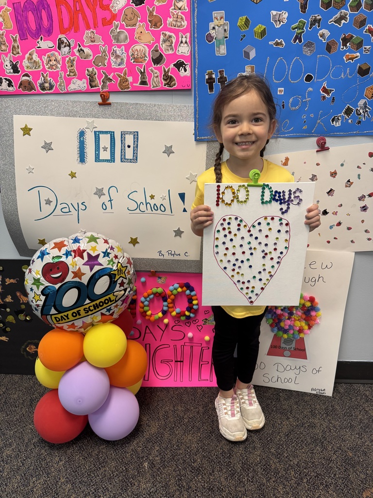 PreK student in front of balloons celebrating 100 days!