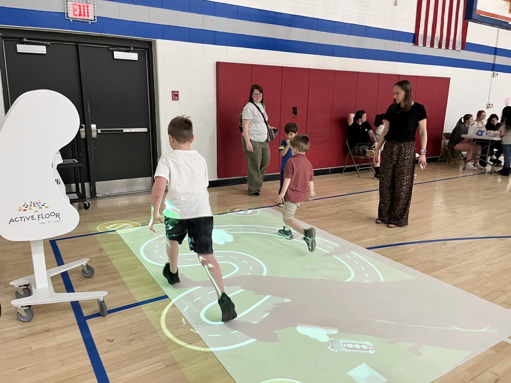 Students playing bike race and learning with active floor