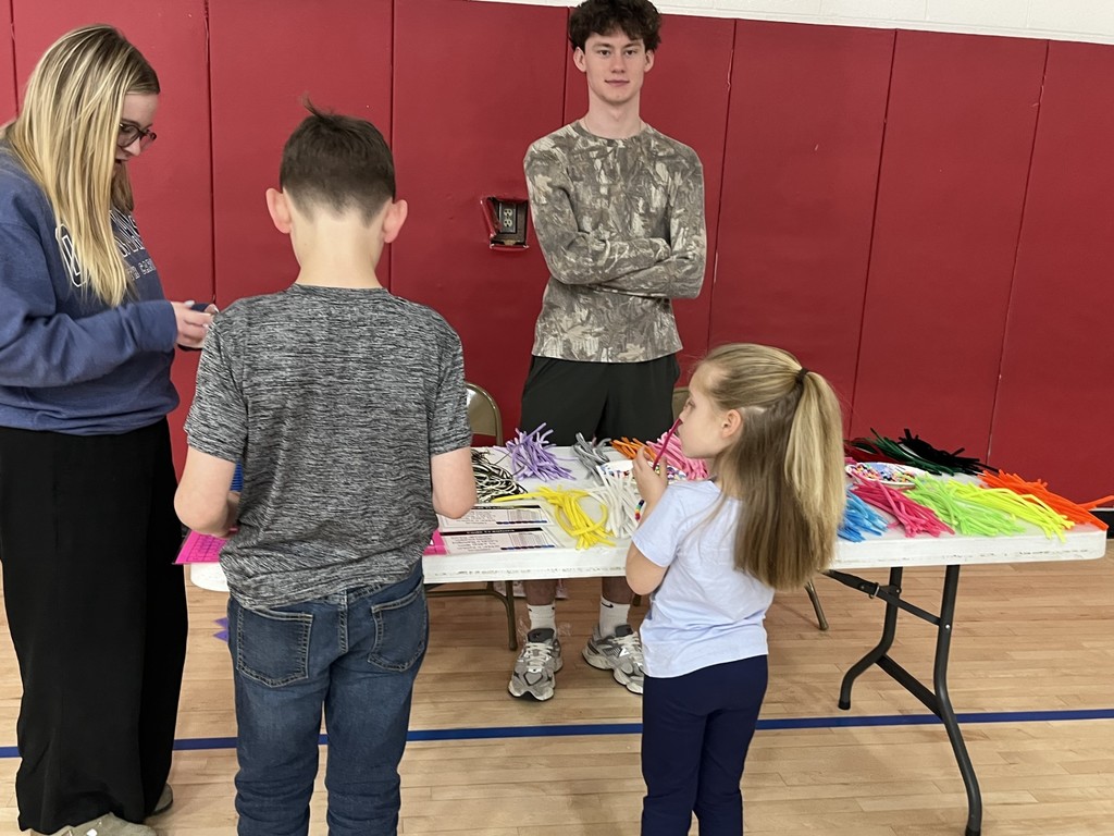Students making coding bracelets