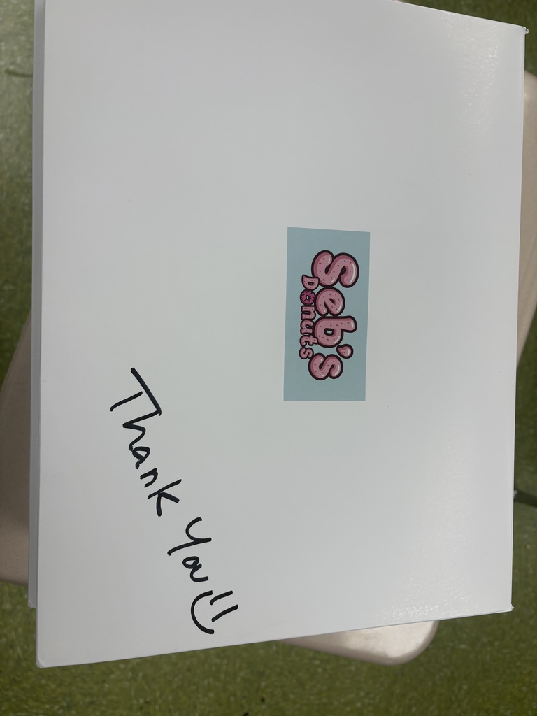Top of a donut box with Seb's Donuts and a written Thank you! on top of the box