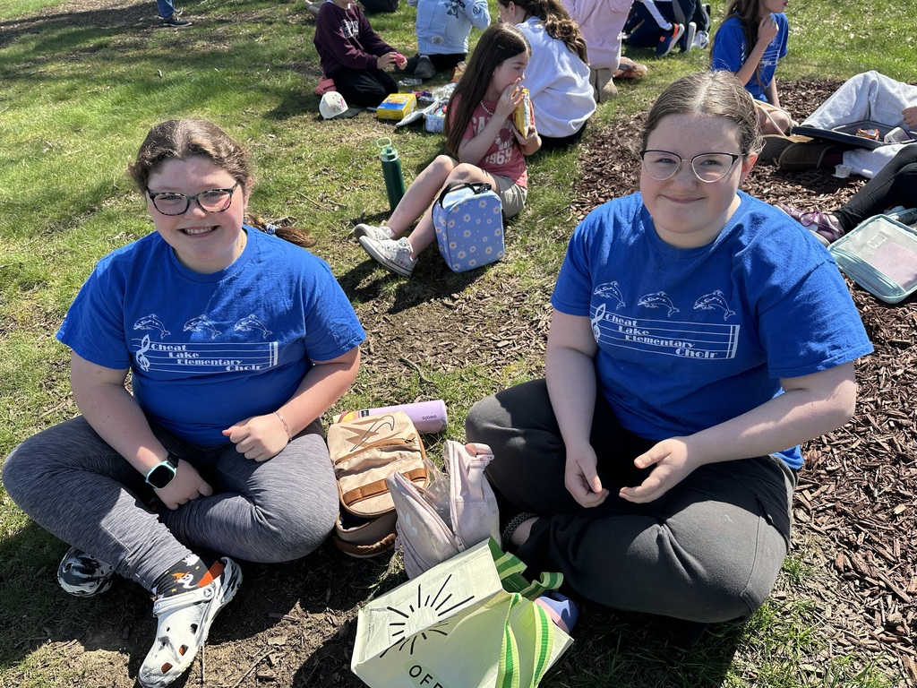 two girls eating lunch outside