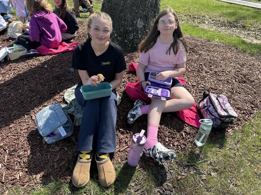 two girls eating lunch outside