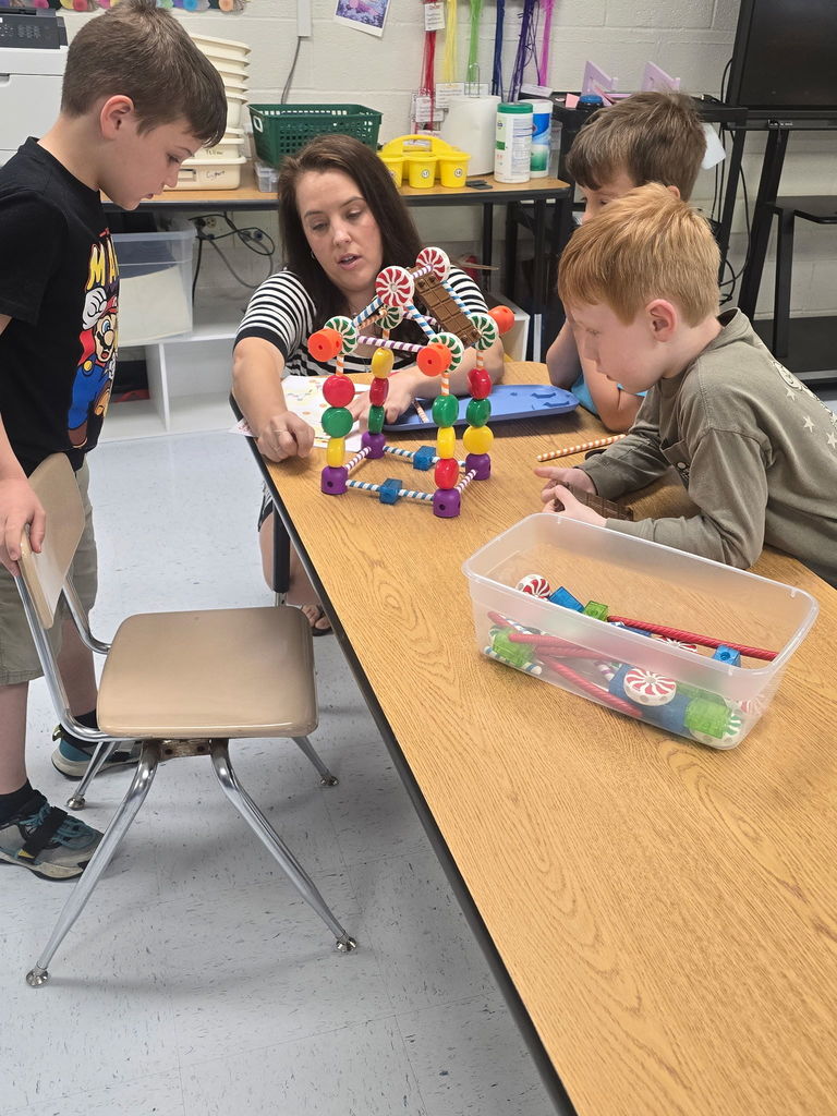 students with teacher building blocks
