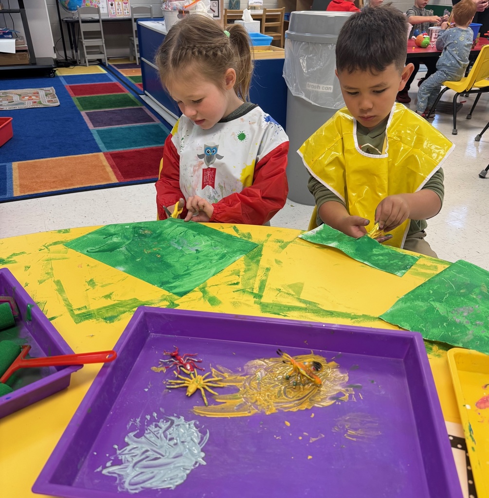 two students cutting paper